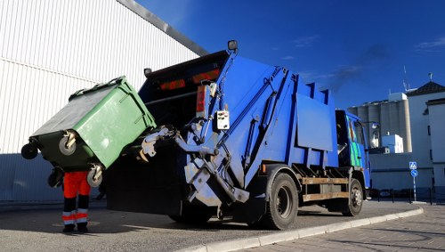 Commercial waste collection trucks in Esher